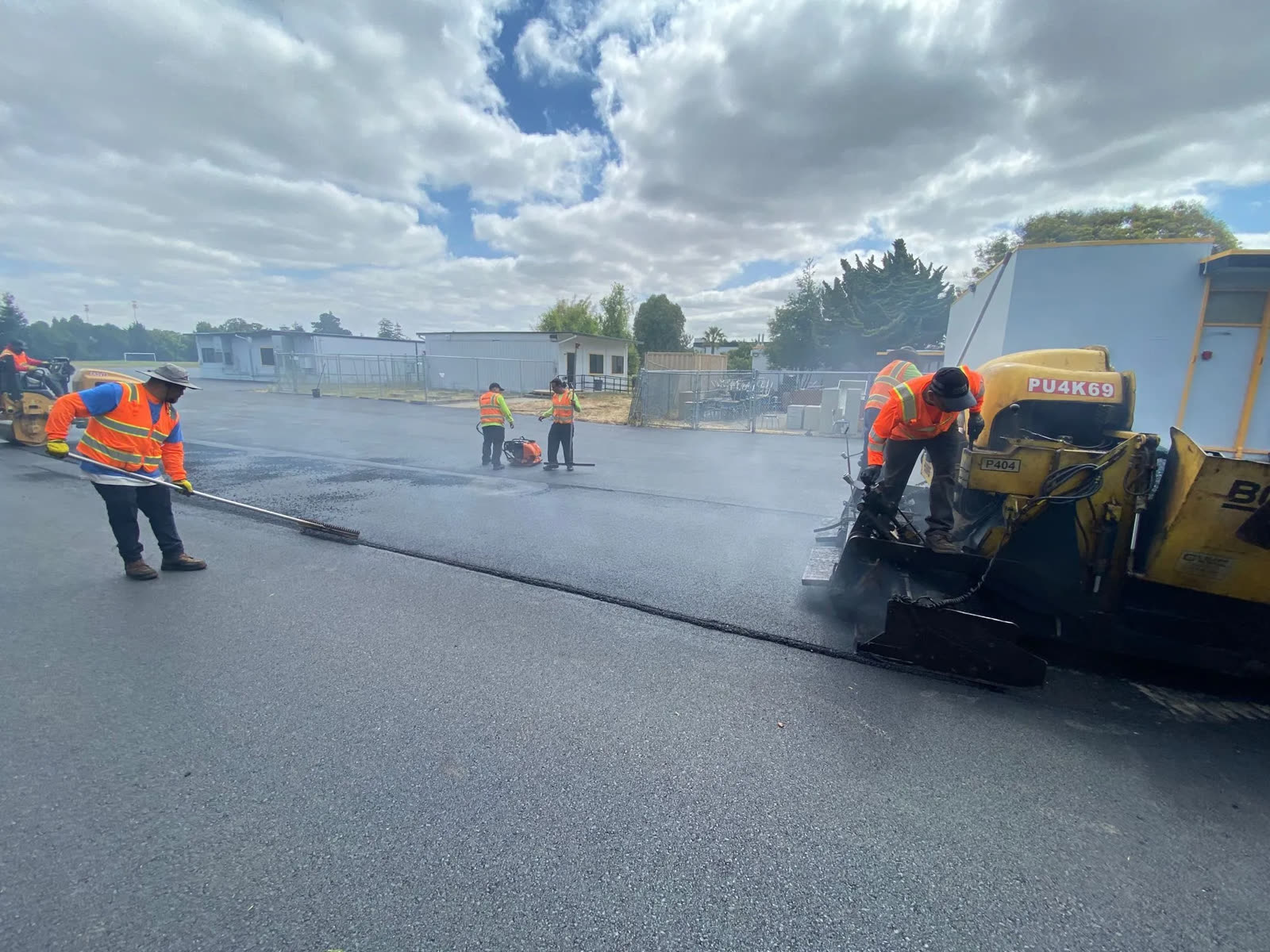 Crew paving a commercial parking lot