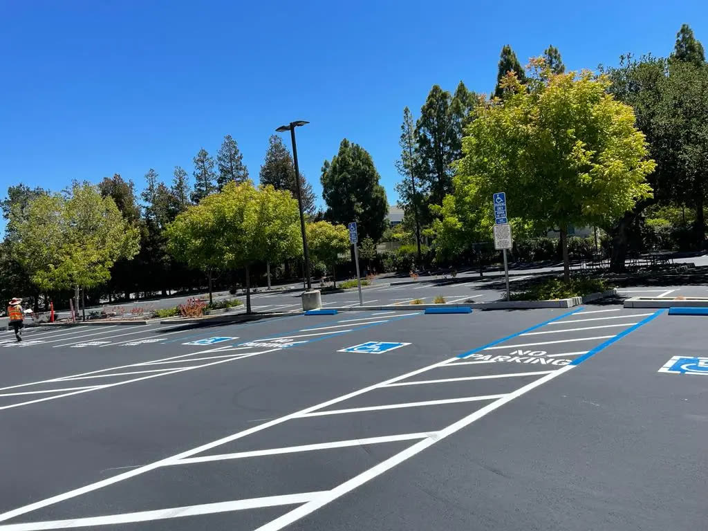 Freshly striped parking lot with new sealcoat and ADA markings
